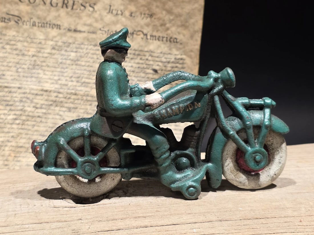 7" Vintage Cast Iron Police Motorcycle Toy Champion Patrol Officer Antique Style: 7" Long Classic reproduction cast iron "Champion" Police Motorcycle, modeled after the famous Hubley and Kenton pull-toys of the early 20th century. It features a uniformed patrol officer riding a gre