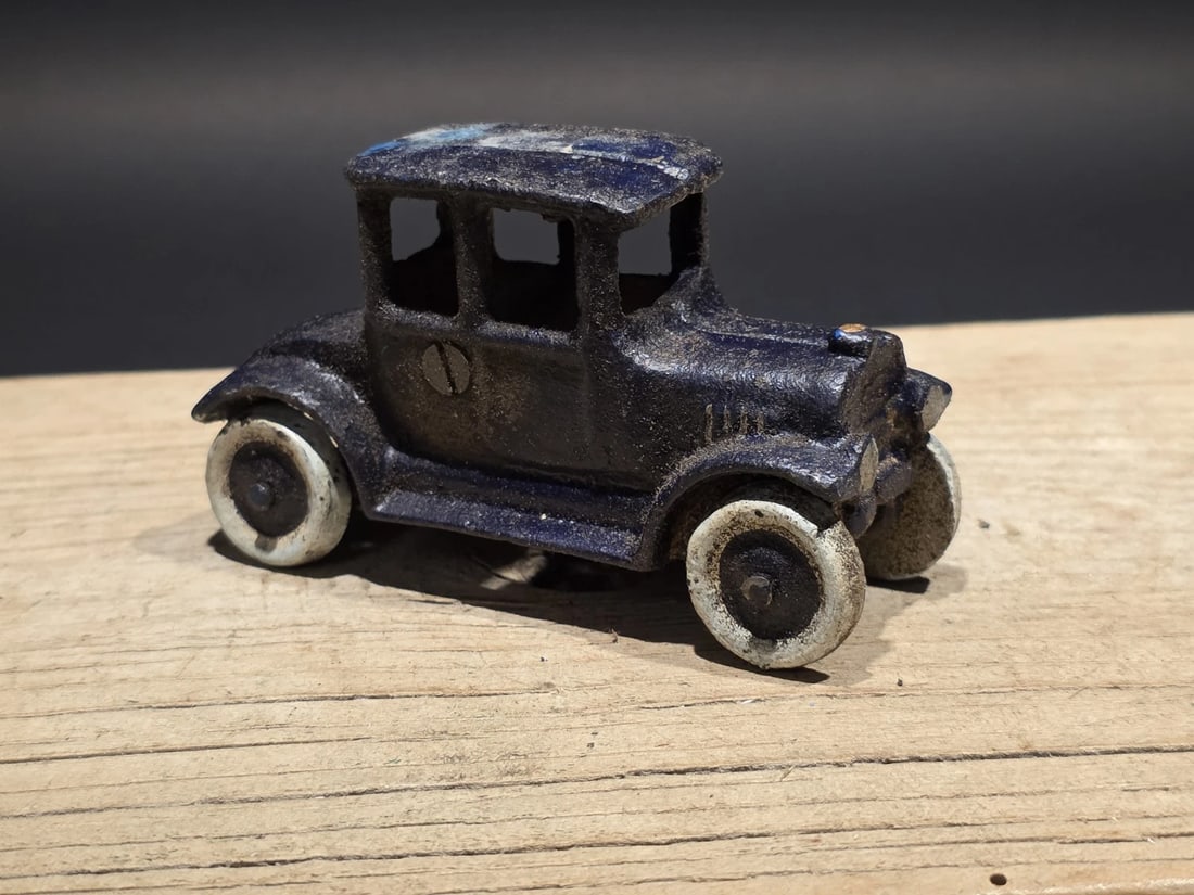 Cast Iron Sedan Toy Car: 4" Long Such a neat reproduction cast iron car! As you can see this heavy cast iron car was wonderfully hand painted and distressed to look original. The car is mostly blue with white wheels. All cast