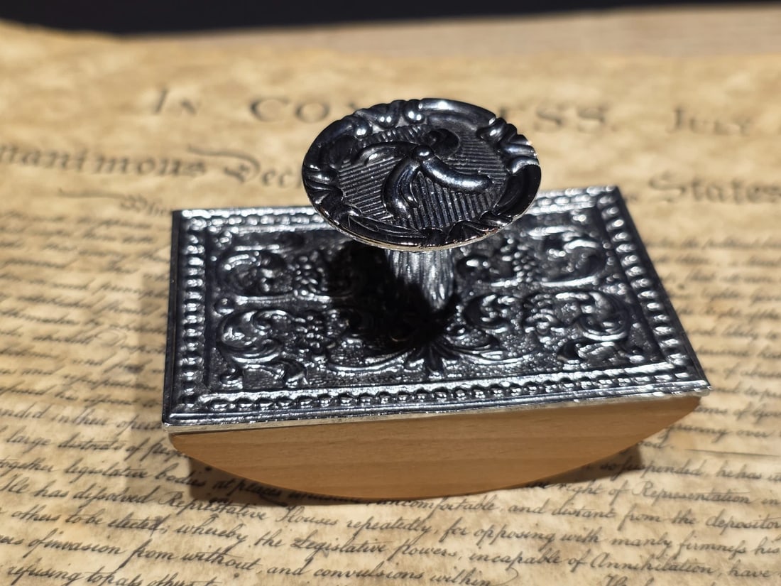 4" Antique Style Silver Metal & Wood Ink Blotter: A classic metal and wood ink blotter with a silver-toned top and smooth wooden base. Designed in the style of traditional writing desks, it would have been used to gently blot excess ink from