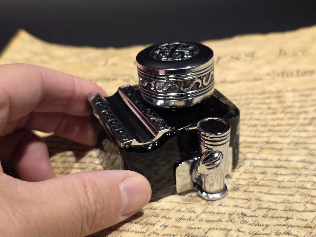 5" Glass Inkwell Pen Rest Filled with 1.75 oz Black Ink: A wonderful reproduction Italian glass inkwell designed with both form and function in mind. Made from dark glass and filled with 1.75 oz of black ink, it features an integrated pen rest that allows