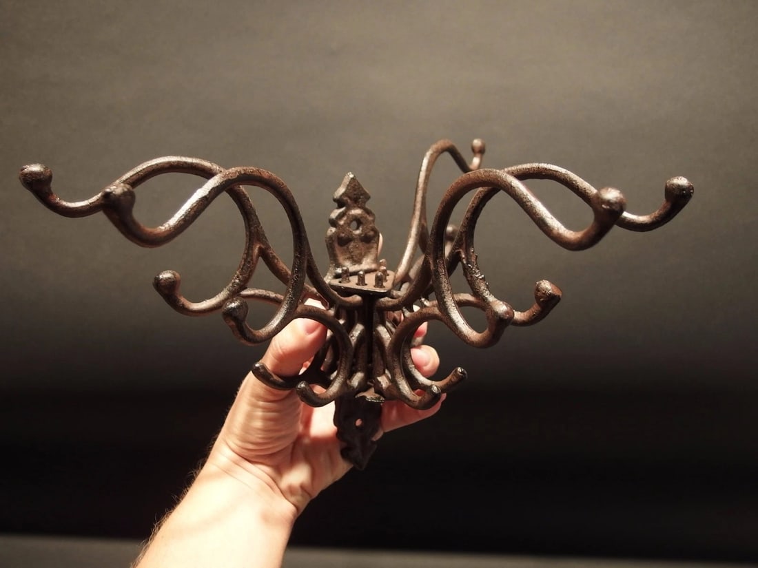 Swivel Folding Coat Hanger Rust Finish: (1) Hook 7" Tall.. 1 3/4" Wide 7 3/4" Extension Great reproduction sturdy iron wall hook cast from an antique. Notice the 5 folding arms Great textured black/brown/rust color powder coat... a very