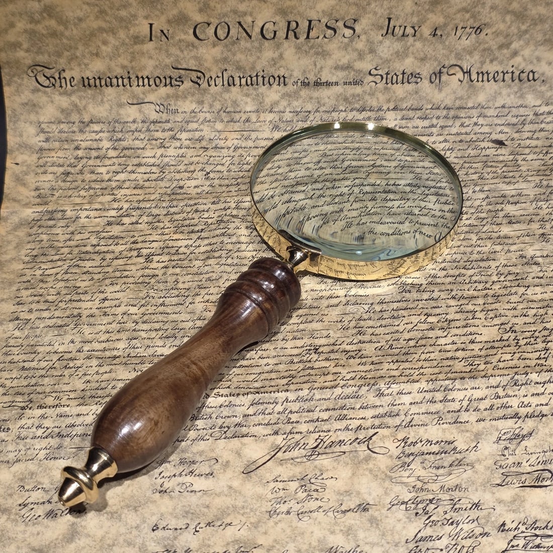 Magnifying Glass w Wood Turned Handle: 4" Wide lens x 9 1/2" Long. Antique-style magnifying glass featuring a brass frame and turned wood handle, inspired by the optical desk tools commonly used during the 19th and early 20th centuries.