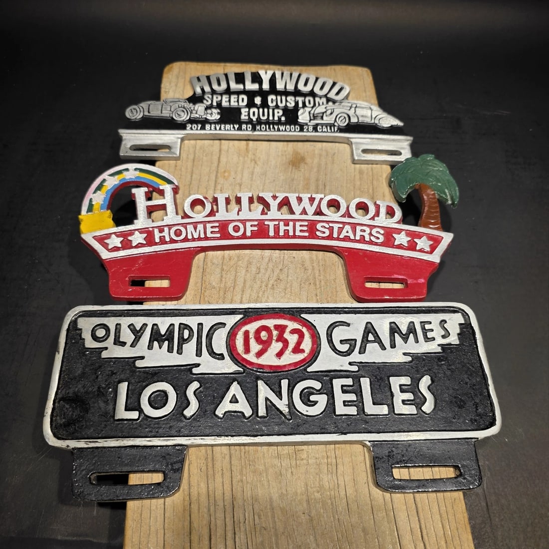 License Plate Topper Set - Hollywood Olympic 1932 Style Toppers: 3 toppers as shown 9 3/4" Wide x 4 1/4" Tall Set of reproduction decorative license plate toppers featuring Los Angeles and Hollywood themes, including "Hollywood - Home of the Stars," "Hollywood