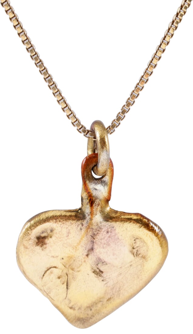 VIKING HEART PENDANT NECKLACE, C.950-1050 AD: Just over 1/2" height (0.55"), plus the loop. The Viking heart in its fully developed form with a cusp top formed by the terminals of the broad borders. The center with an elaborate trefoill (foliate