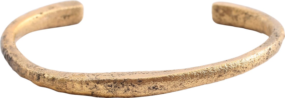 VIKING WOMAN'S BRACELET, 850-1050 AD: Gilt bronze, D section, rounded face and flat sided and inside. Swelled in the middle and both ends. Over 2" inside dimension. Plain but for a pair of low swells to the middle and three each end. Now 
