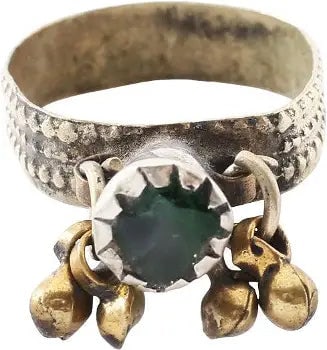 EASTERN EUROPEAN GYPSY RING, 19TH C., SIZE 9 3/4: Size 9 3/4 with white metal band, 5.9mm width decorated in three crenulated bands. The shoulders with two jingles each flanking the inverted conical bezel with a green " stone" . A little wear from us