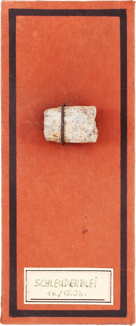 MEDIEVAL EUROPEAN SLING PROJECTILE: 14th-15th century. Lead cylinder just under 5/8" in diameter, the ends depressed and cut roughly to provide cutting edges. Used both on the battlefield and in siege warfare. Found in Bavaria