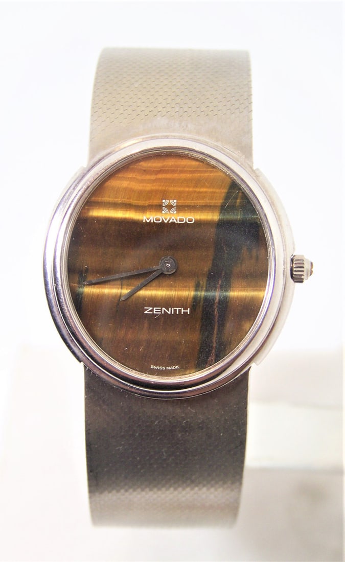 Solid 18k White Gold MOVADO by ZENITH Mens Watch TIGER Eye Dial* EXLNT: Solid 18k White Gold MOVADO by ZENITH Mens Watch TIGER Eye Dial* EXLNT Condition ? This Mens Movado watch is Swiss made. Great present for yourself or someone you love as well as for vintage collector