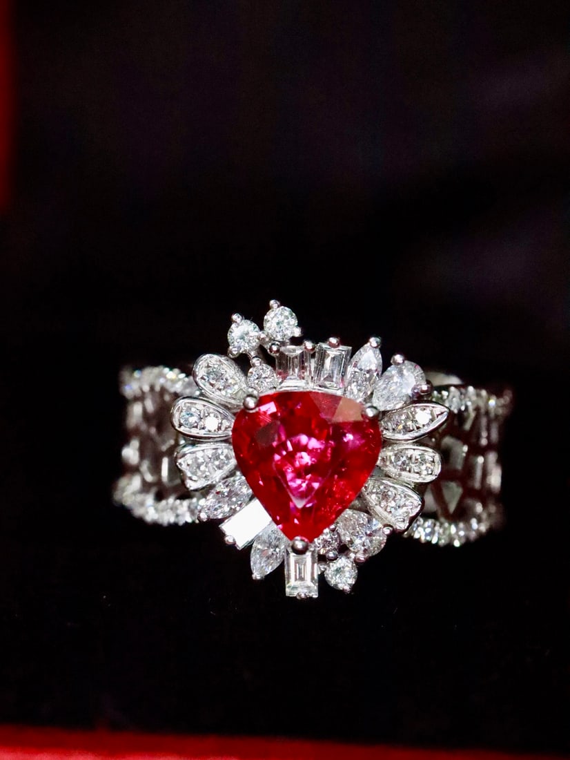 PT950 Natural Unheated Ruby Ring: Title: PT950 Natural Unheated Ruby Ring Description: This platinum ring features a natural unheated ruby as the main stone, with a unique design of interwoven shapes and a hollow-set band that