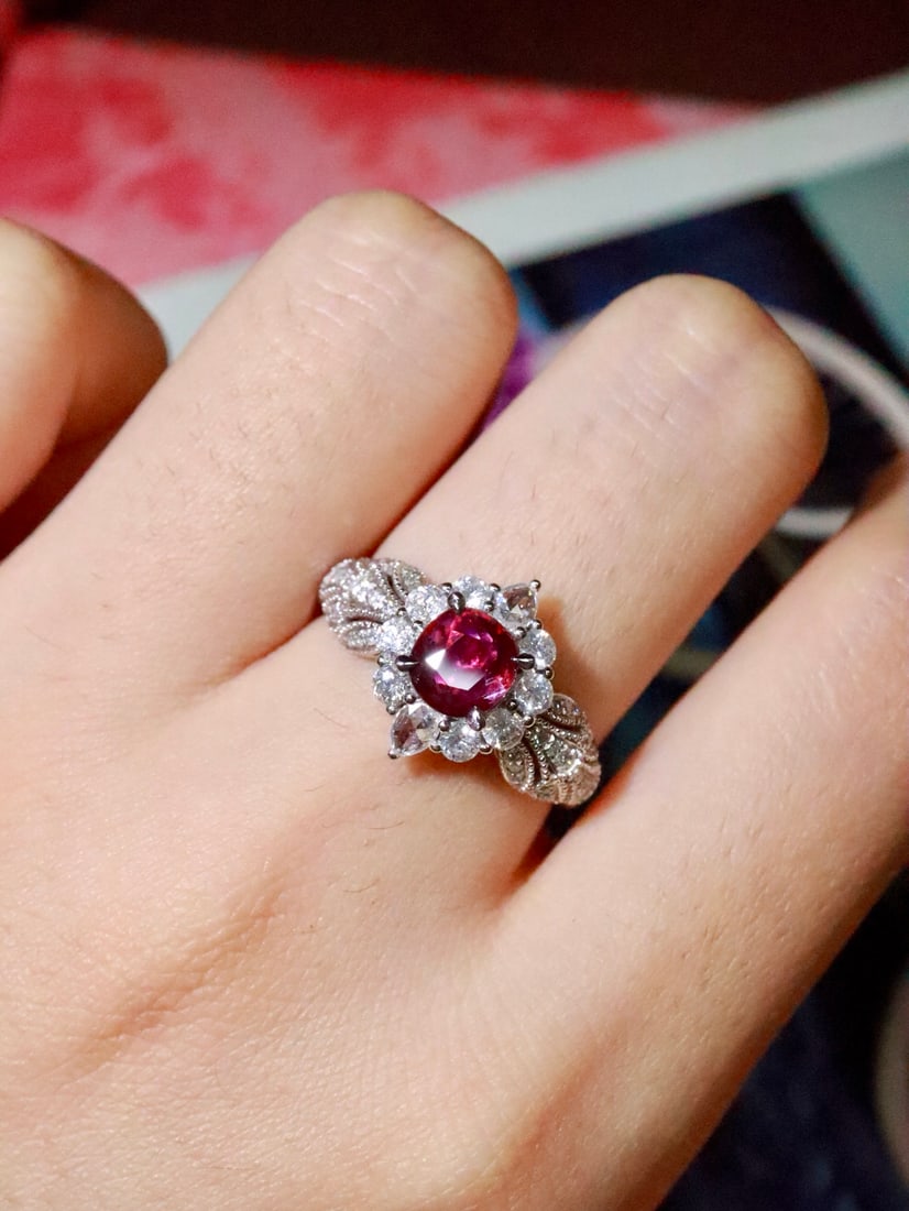 Platinum Natural Ruby Ring: Title: Platinum Natural Ruby Ring Description: This ruby ring features exquisite design, with a vibrant color and excellent clarity of the ruby. The surrounding diamonds are brilliantly white, perfect