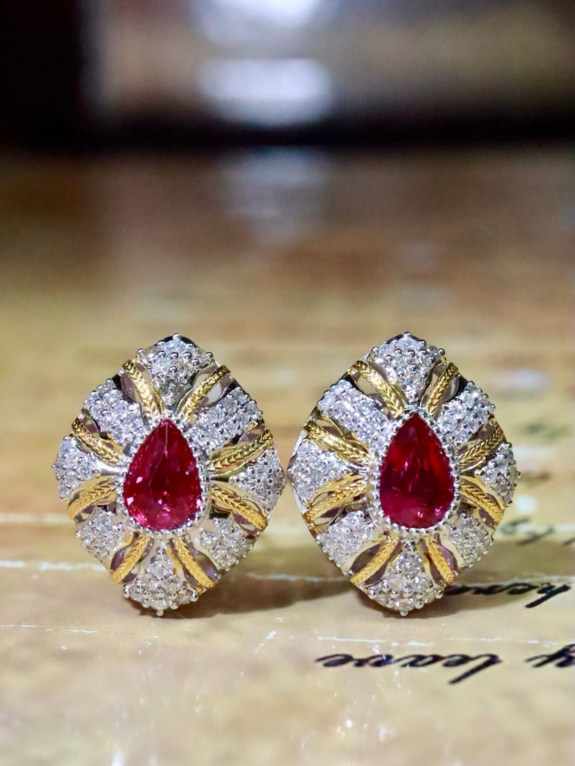 18K Gold Natural Unheated Ruby Earrings: Title: 18K Gold Natural Unheated Ruby Earrings Description: These earrings showcase exquisite vintage style with bright pear-shaped unheated rubies in a captivating pigeon blood red hue. The sparkling