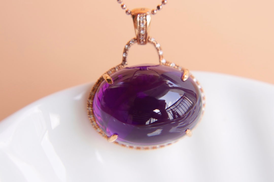 18K Gold Natural Amethyst Pendant: Title: 18K Gold Natural Amethyst Pendant Description: This 18K gold pendant features a stunning natural amethyst weighing 20.4 carats, complemented by 46 sparkling diamonds, showcasing an exquisite