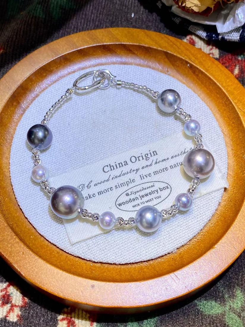S925 Silver Elegant Sea Pearl Bracelet: Title: S925 Silver Elegant Sea Pearl Bracelet Description: This bracelet is crafted from S925 silver, featuring 6-7mm mirror-like silver-blue sea pearls and 11-12mm lustrous Tahitian black pearls, sho