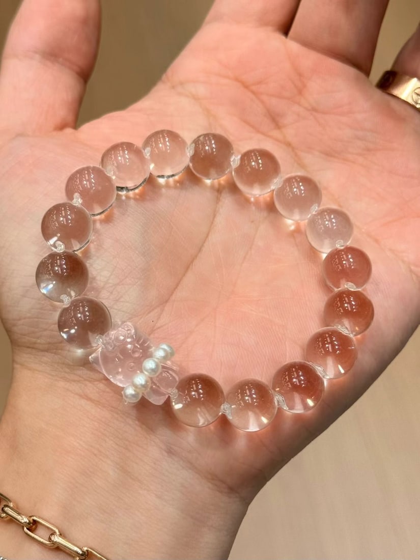 Natural White Water Bead Bracelet: Title: Natural White Water Bead Bracelet Description: This bracelet is made of natural double A grade white water beads, approximately 11mm in diameter, complemented by a pink crystal KT cat carving