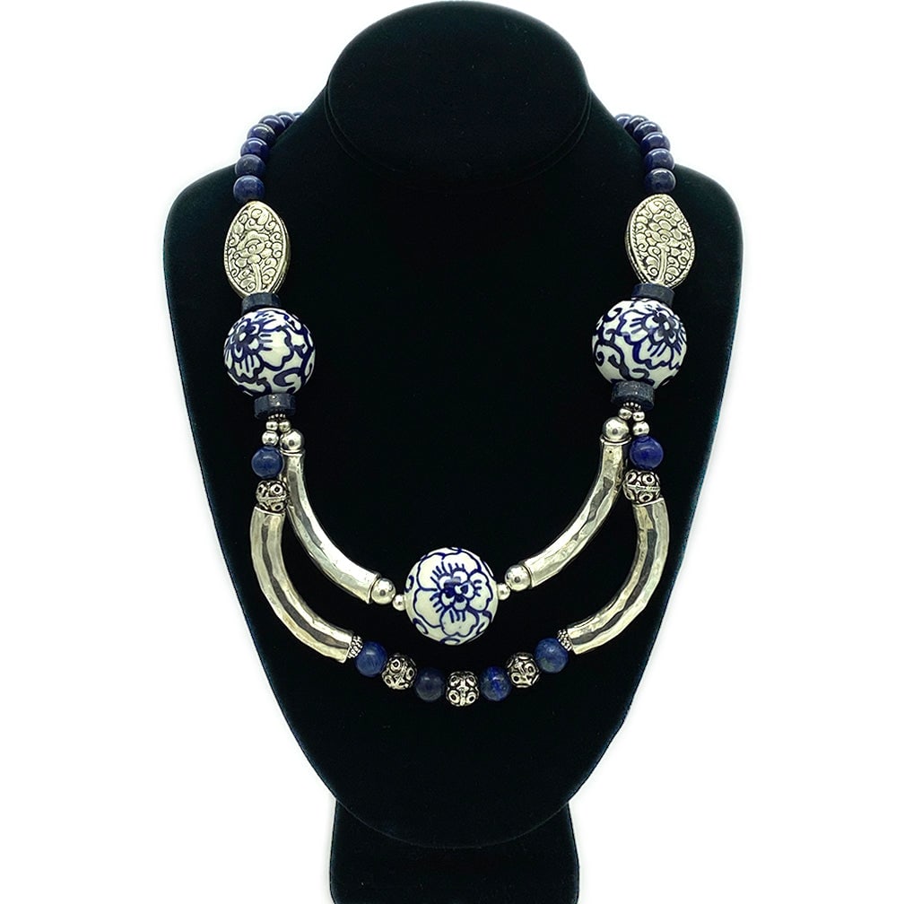 Lapis Lazuli and Porcelain Bib Necklace: This is a one of a kind lapis lazuli and porcelain bib necklace. It was created with 10 mm smooth lapis lazuli beads, three 28 mm blue on white porcelain beads and connected with four silver-tone