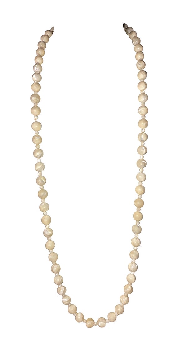 Mother of Pearl Shell Hand Cut Bead Necklace: Title:Mother of Pearl Shell Hand Cut Bead Necklace Description:Hand Cut Mother of Pearl Shell Hand Bead Necklace. Circa, 1940's. Measures 33" long and 1/4" wide. Beads are 10 mm's and 3.5 mm's