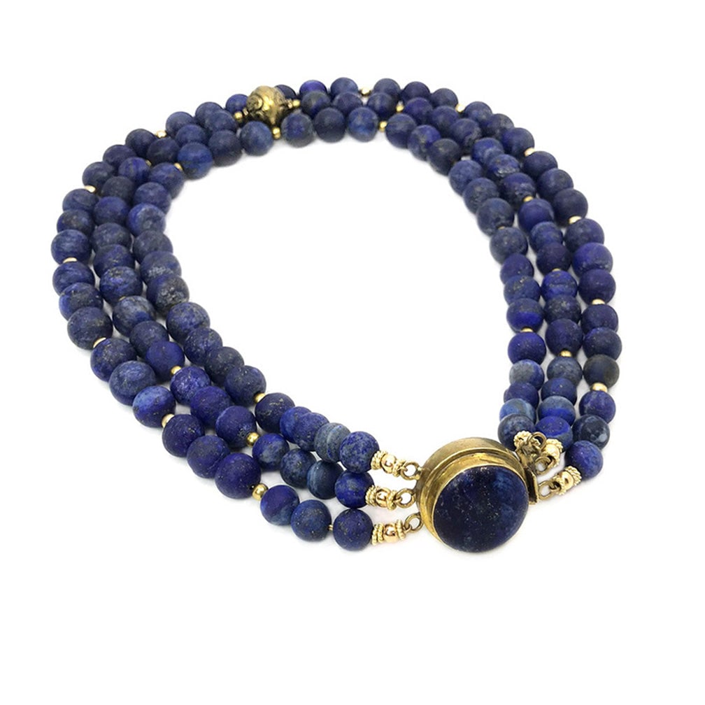 Lapis Lazuli Triple Strand Necklace: We created this triple strand necklace with 8-12 mm matte finished lapis lazuli beads, one large brass decorated bead as focal point. and a 24 mm lapis lazuli brass box clasp. Dimensions: 18 inch Rese