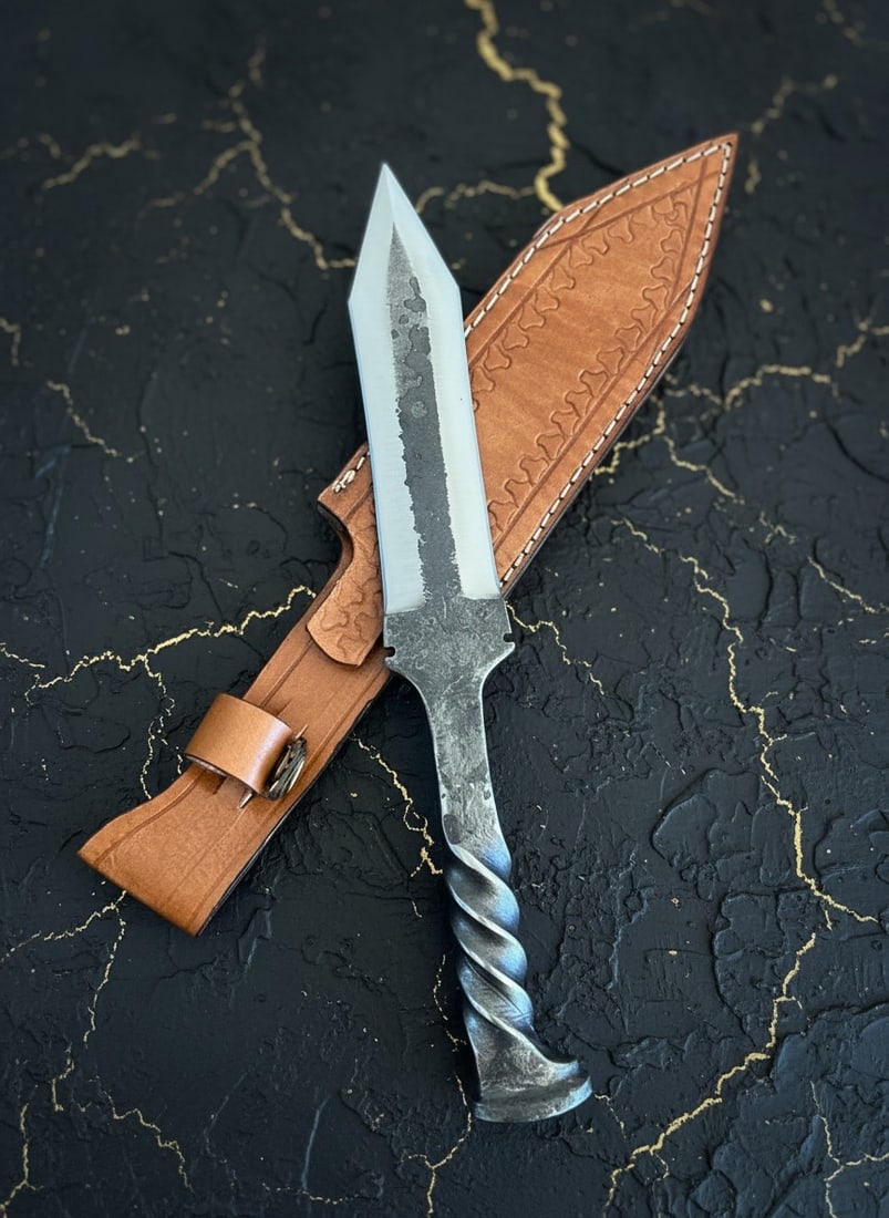 Custom 12.5" D2 Steel Railroad Spike Knife with Handcrafted Leather Sheath: Title:Custom 12.5" D2 Steel Railroad Spike Knife with Handcrafted Leather Sheath Description:This hand forged knife features a 11.5-inch overall length and comes with a durable cowhide leather sheath.