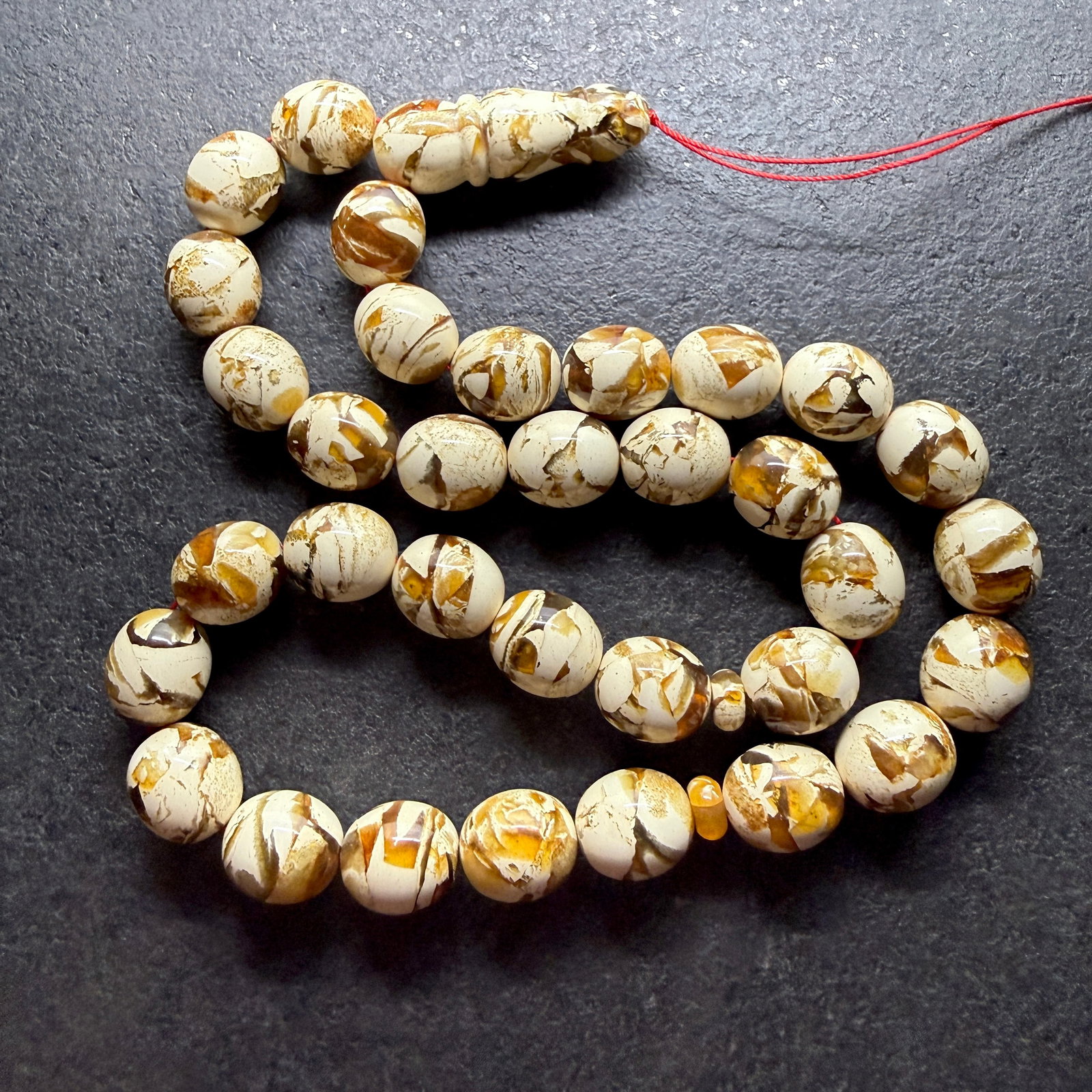 Grand Amber Tesbih made from Round Amber beads with White Pattern: Title:Grand Amber Tesbih made from Round Amber beads with White Pattern Metal:None Gemstone:Reconstituted Amber Weight:90.9 g Size:17x15mm Made of:(Reconstituted Amber or Whole Stone):Reconstituted