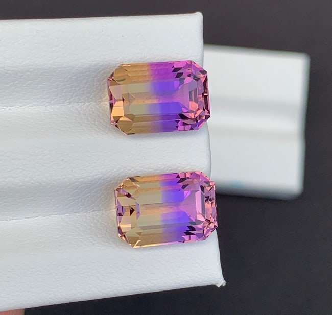 Emerald Cut Bolivian Ametrine Gemstone Pair: 11.90 CT, Royal Purple/Mango Yellow: Emerald Cut Bolivian Ametrine Gemstone Pair: Royal Purple/Mango Yellow Properties : Birthstone : February Birthstone Zodiac Sign : Aquarius Birthstone Chakras : crown or "bliss" chakra Healing Propert
