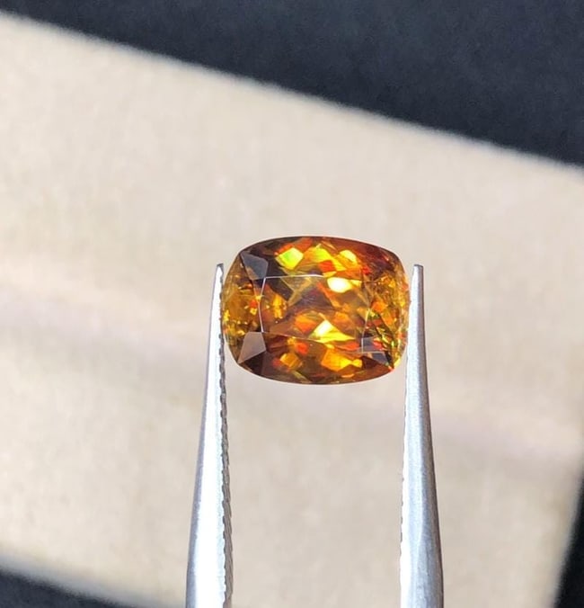 Sparkling Rainbow Fire Natural Cushion Cut Sphene Loose Gemstone For Engagement Ring - 1.90 Carat: Materials: Gemstone: Sphene Carat weight: 1.95 This stunning full fire sphene titanite loose gemstone features a captivating cushion cut that enhances its brilliance and beauty. With its vibrant play