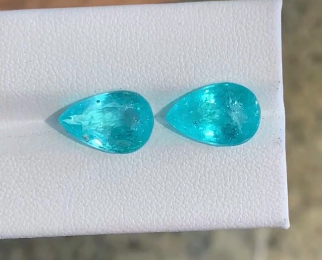 9.17 Carat Natural Stunning Greenish Blue Paraiba Tourmaline Gemstone Pair, Featuring Pear Cut Gems: Double the neon brilliance with this flawlessly matched pair of pear-cut Paraiba Tourmalines. Masterfully shaped into elegant teardrops, these stones feature perfectly balanced proportions and mirrore