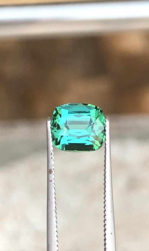 Afghanistan Bluish Green Tourmaline Cushion Cut Gemstone For Engagement RIng - 1.970 Carat: Gemology: * Weight : 1.970 carat * Dimension : 7.2*6.5*5.4 mm * Color: Blue Green * Clarity : Eye Clean * Shape : Cushion Cut * Hardness : 7 to 7.5 * Mineral Class : Silicates * Origin : Afghanistan *