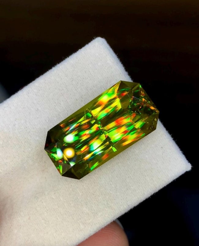Natural Madagascar Sphene (Titanite) 17.00 Carat - Precision Cut Rainbow Fire Loose Gemstone: Bring extraordinary brilliance to your gemstone collection with this Natural Madagascar Sphene (Titanite) weighing 17.00 carats. Expertly precision cut into a striking rectangular fancy cut, this
