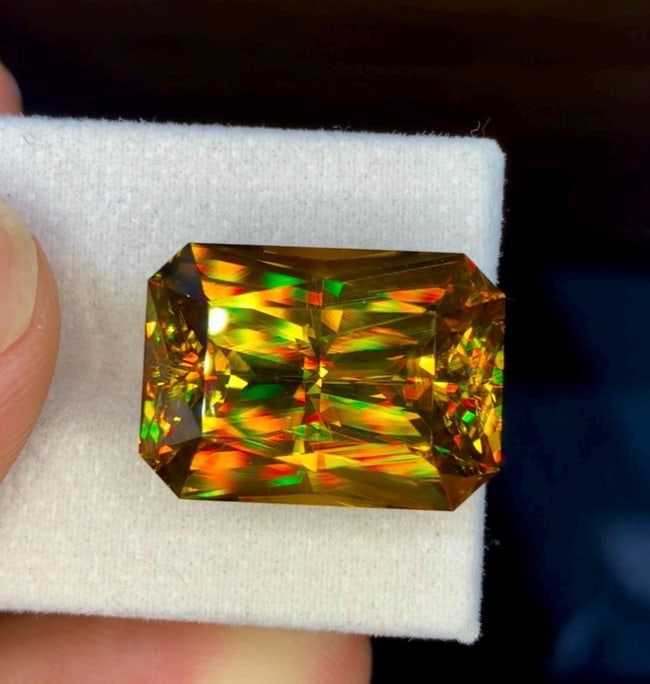 Natural Madagascar Sphene (Titanite) 32.31 Carat - Precision Cut Rainbow Fire Loose Gemstone: Bring extraordinary brilliance to your gemstone collection with this Natural Madagascar Sphene (Titanite) weighing 32.31 carats. Expertly precision cut into a striking rectangular fancy cut, this exce