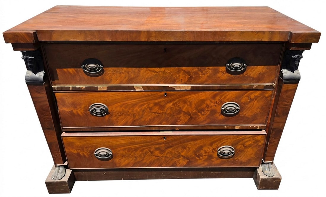 American Classical Flame Mahogany Chest of Drawers: An American Classical flame mahogany chest of drawers, likely early 19th century. The chest features three full-width drawers with highly figured flame mahogany veneers, original brass hardware, and