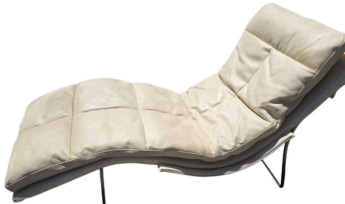 Mid-Century Modern Tan Leather Chaise Lounge with Chrome Frame: This chaise lounge features a tan leather upholstery with button tufting, supported by a sleek chrome-plated metal frame. The design is indicative of Mid-Century Modern aesthetics, offering both