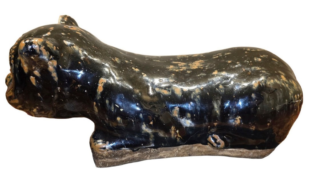 Vintage Black Glazed Ceramic Cat Sculpture: This vintage ceramic cat sculpture features a dark, almost black, glaze with mottled brown and white accents, creating a unique mottled appearance. The stylized cat is depicted in a reclining