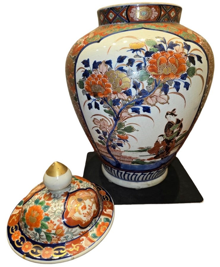 Large Japanese Imari-Style Porcelain Ginger Jar with Lid: A large Japanese Imari-style porcelain ginger jar with a domed lid. The jar features traditional Imari motifs with vibrant orange, blue, green, and gilt accents on a crackled white ground. The design