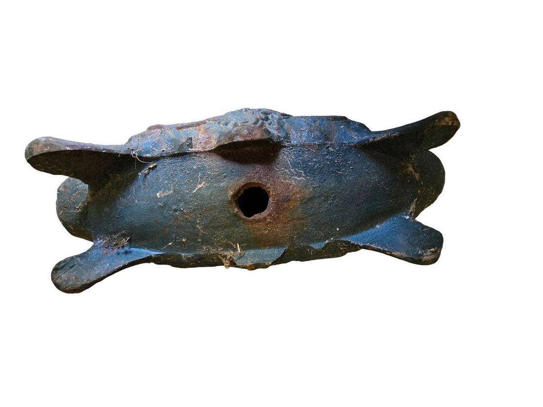 Cast Iron Planter with Grape Motif: A heavy cast iron planter, likely antique or vintage, featuring an embossed grape and vine motif. The planter has a rectangular shape with rounded ends and stands on four feet. It shows significant we