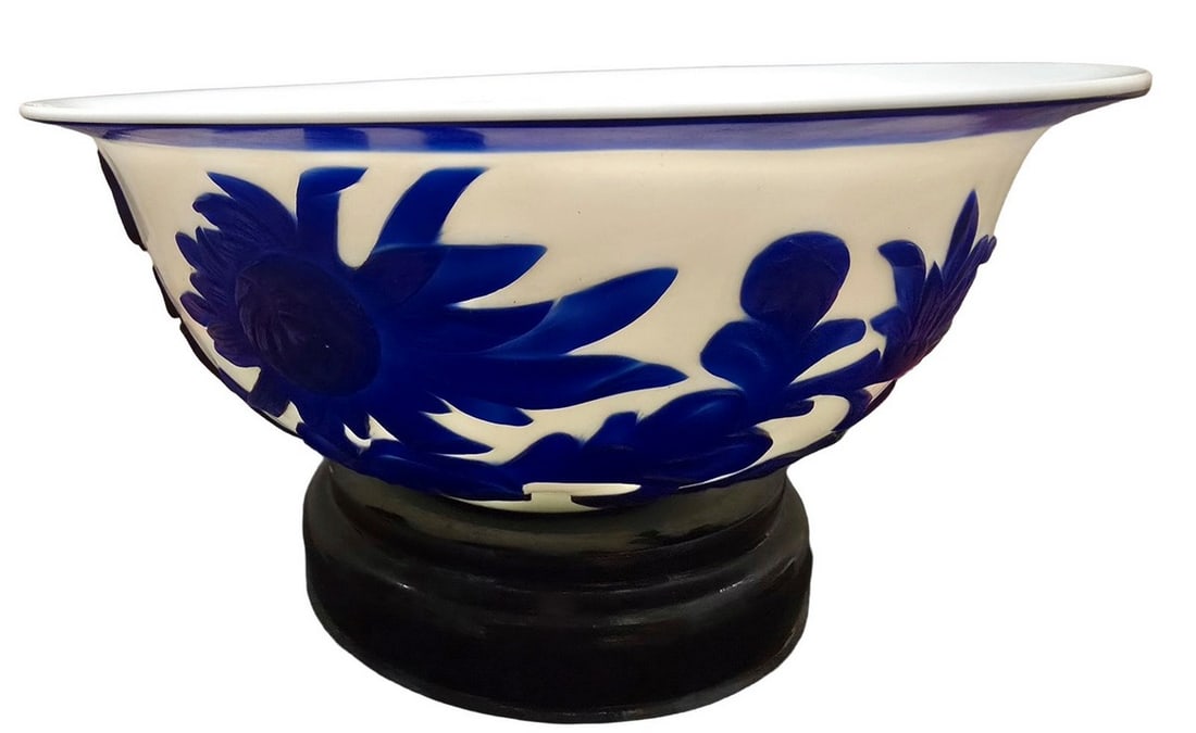 Decorative Ceramic Bowl with Blue Bird and Floral Motif: This decorative ceramic bowl features a white glaze exterior adorned with a vibrant blue raised relief design. The motif depicts a bird in flight amidst stylized floral and leafy patterns, with a
