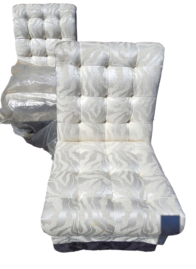 Pair of Tufted Upholstered Armless Chairs: Pair of contemporary armless chairs, upholstered in a cream and silver patterned fabric with tufted backs and seats. The fabric features a subtle zebra or tiger stripe pattern. One chair is currently