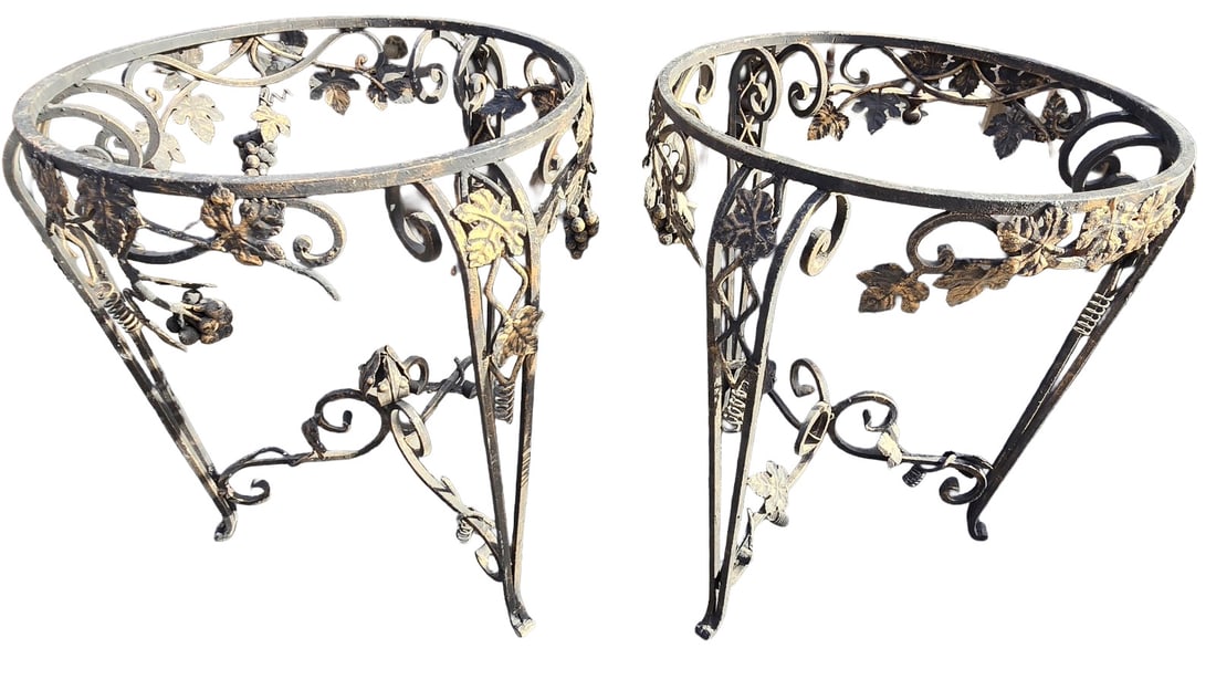 Pair of Wrought Iron Console Table Bases with Grapevine Motif: A pair of wrought iron console table bases, possibly for a demi-lune or console table, featuring an ornate grapevine motif with leaves and clusters of grapes. The iron has a dark, aged finish with