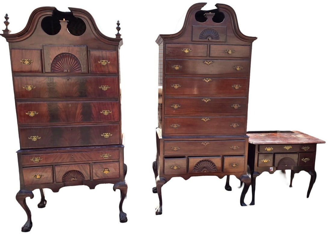 Pair of Chippendale Style Mahogany Highboys: A pair of Chippendale style mahogany highboys, each featuring a broken arch pediment with finials, shell carved drawers, and cabriole legs with ball and claw feet. The upper case has multiple drawers 