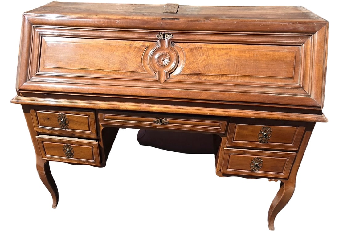 Louis XV Style Slant-Front Desk: A handsome Louis XV style slant-front desk, crafted from richly-toned wood with elegant curves and ornate brass hardware. The desk features a hinged slant-front that opens to reveal a writing surface 