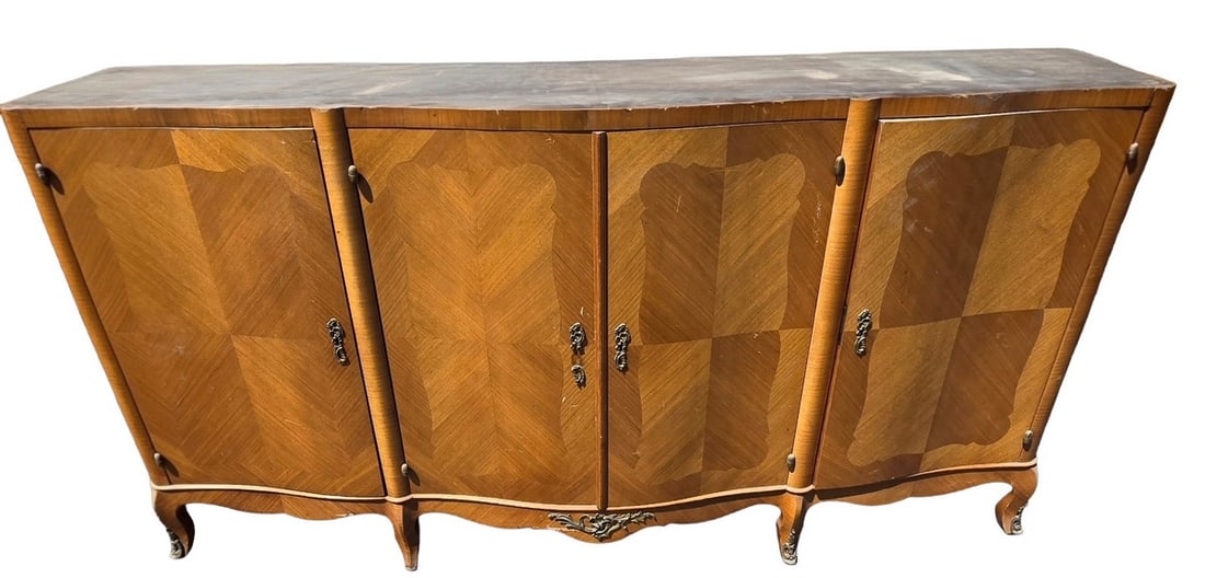 Vintage Marquetry Sideboard / Credenza: A vintage sideboard or credenza featuring intricate marquetry work in a geometric pattern across its four doors. The top surface appears to be a darker, possibly stained, wood. The cabinet has a