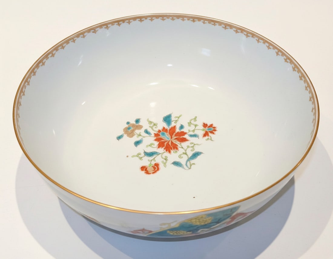 Large Chinese Export Porcelain Punch Bowl with Figural and Floral Decoration: This large Chinese Export porcelain punch bowl features vibrant polychrome enamels depicting figural scenes around the exterior and floral motifs on the interior base and rim. The interior boasts a