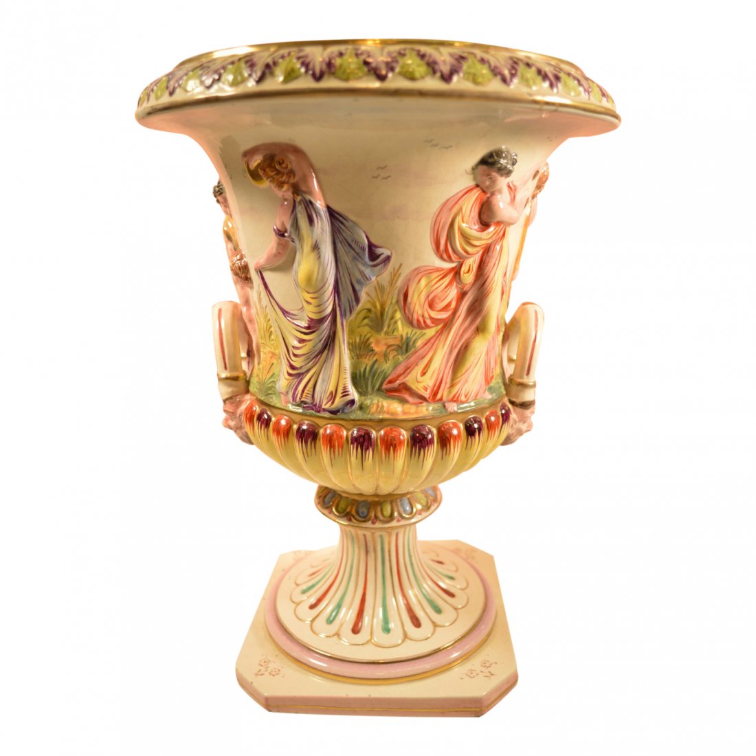 Capodimonte Porcelain Vase: This magnificent Capodimonte porcelain vase will enhance any room. It has vibrant multi-color themes of sculptured figurines all around the middle with two man figurines on each side. The base has a b