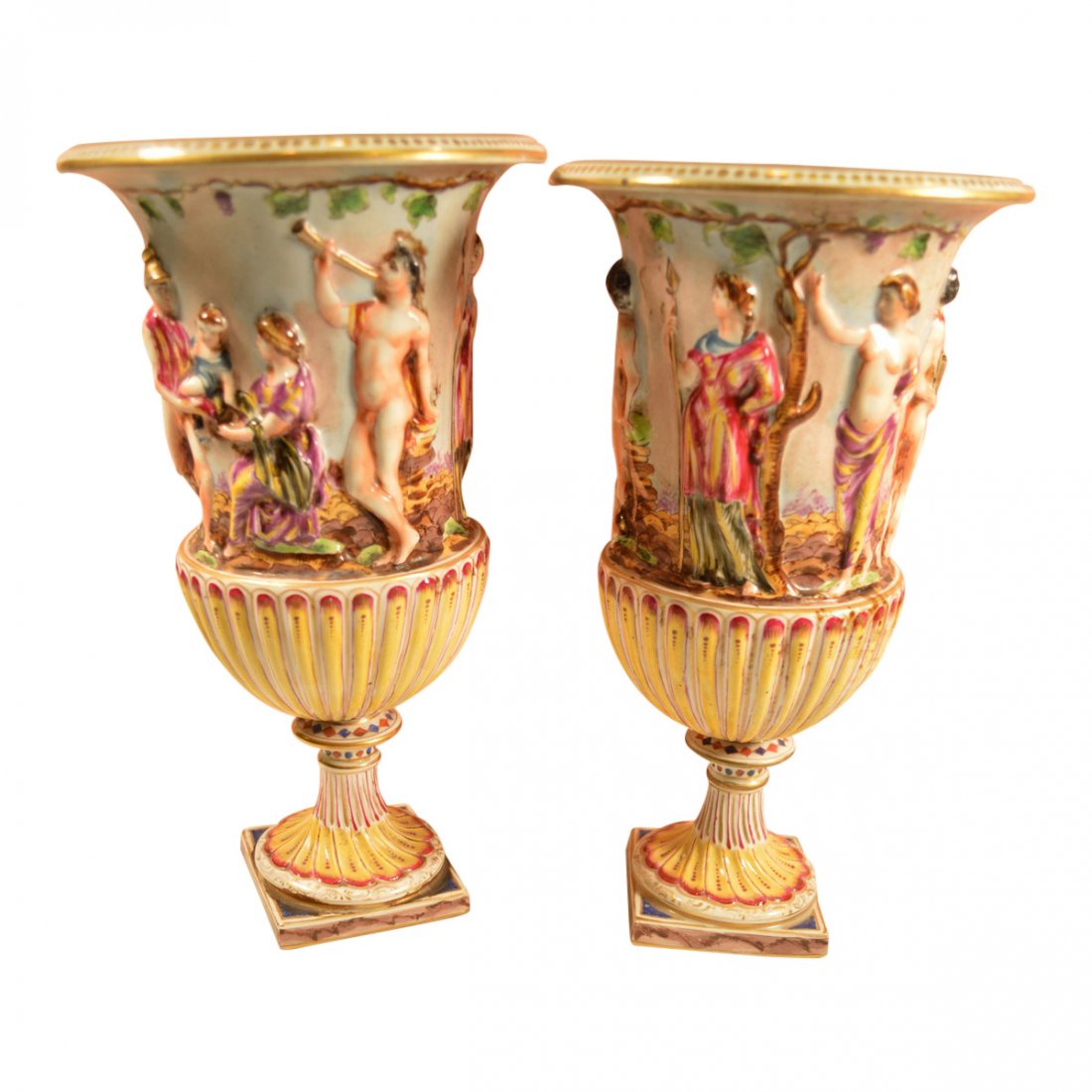 Pair Of Capodimonte Vases: Each of these Capodimonte vases has a vibrant color scheme, in addition to a stamp at the bottom. These vases also feature moulded figures that reflect the elegance of European decorative arts. Establ
