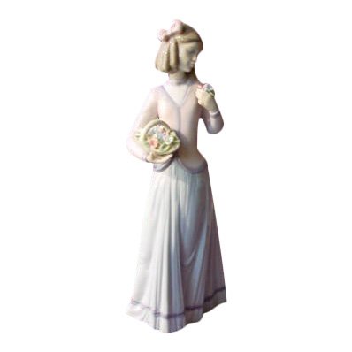 Lladro: Innocence in Bloom: Lladro Figurine, Innocence in Bloom Reference: 1007644 Issue Year: 1996 Retirement Year: 1998 Sculptor: Jose Puche Size: 9 3/4 inches x 4 1/4 inches Lladro is a Spanish company based in Tavernes Blanq