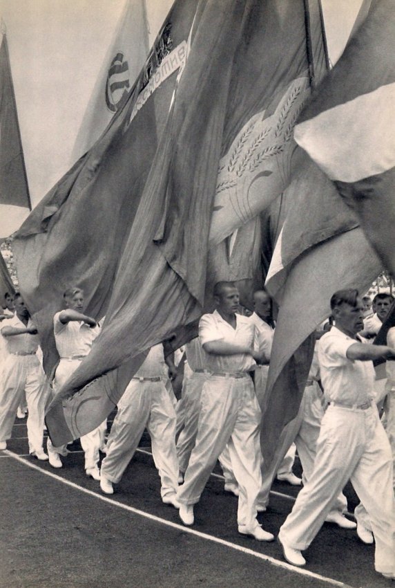 Cartier-Bresson: Sports Parade in Moscow: Medium: Sheet-fed Copper Plate Gravure Date: 1955 Printer: Draeger Freres, France Image Size: 9 x 13 inches Henri Cartier-Bresson was a French photographer who specialized in humanist photography. He 
