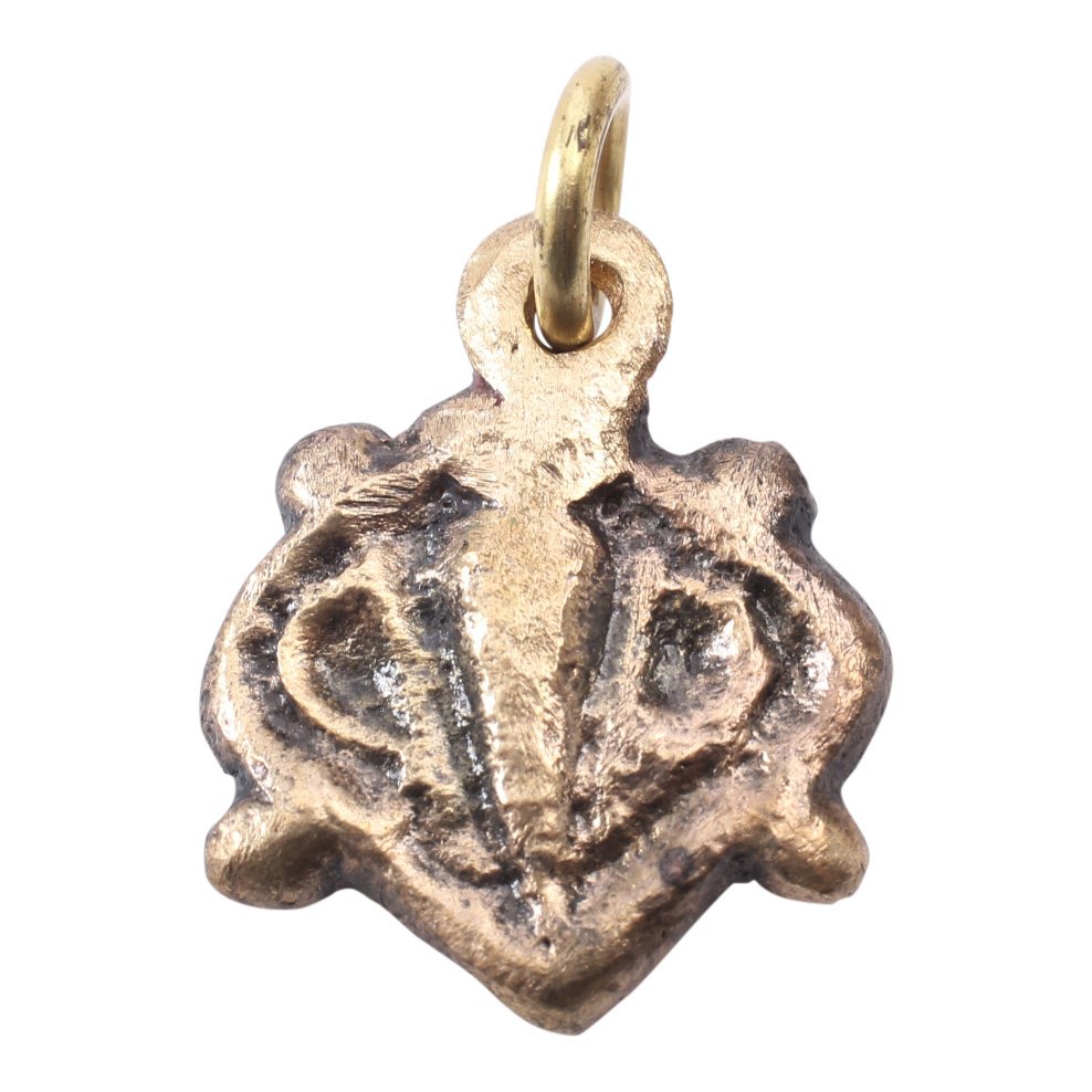 Viking Heart Pendant 10-11th C: Item: Viking Heart Pendant Date: 900-1050 A.D. Material: Gold overlay Size: 3/4 inch Divided heart motif with vertical spear shaped ridge flanked by delineated half hearts. The heart was a male symbol