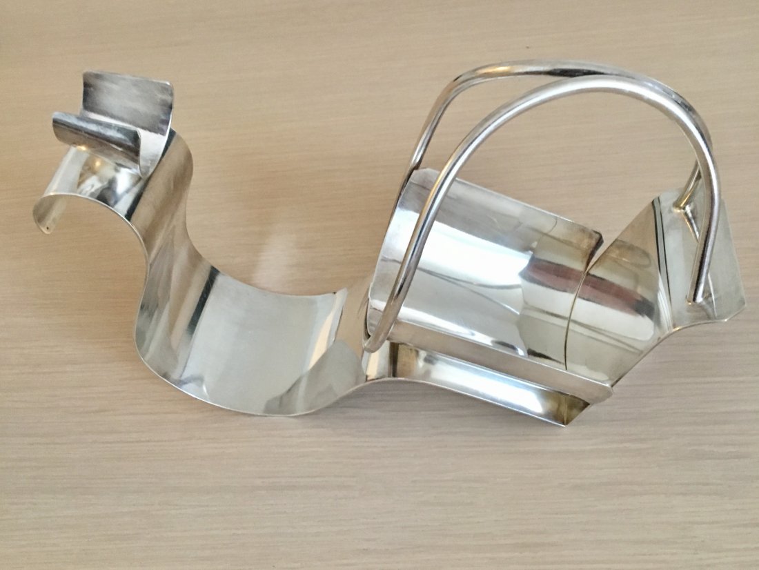 Vintage Silver Plated Wine Cradle, 1980: Item: Vintage Silver Plated Wine Cradle Marked J, Deyaner inside a cartouche Material: Silver plated Date: ca. 1980 Size: 28 cm long x 17 cm high x 10 cm deep This wine bottle cradle will accept a sta