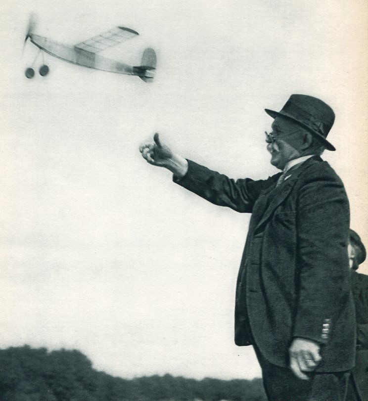 Robert Doisneau: Playing with Planes: Print Title: Playing with Planes Artist: Robert Doisneau Medium: Vintage Sheet-Fed Gravure Printing Date: 1956 Printer: Braun & Cie, France Image Size: 7 x 8 inches Robert Doisneau was a French photog