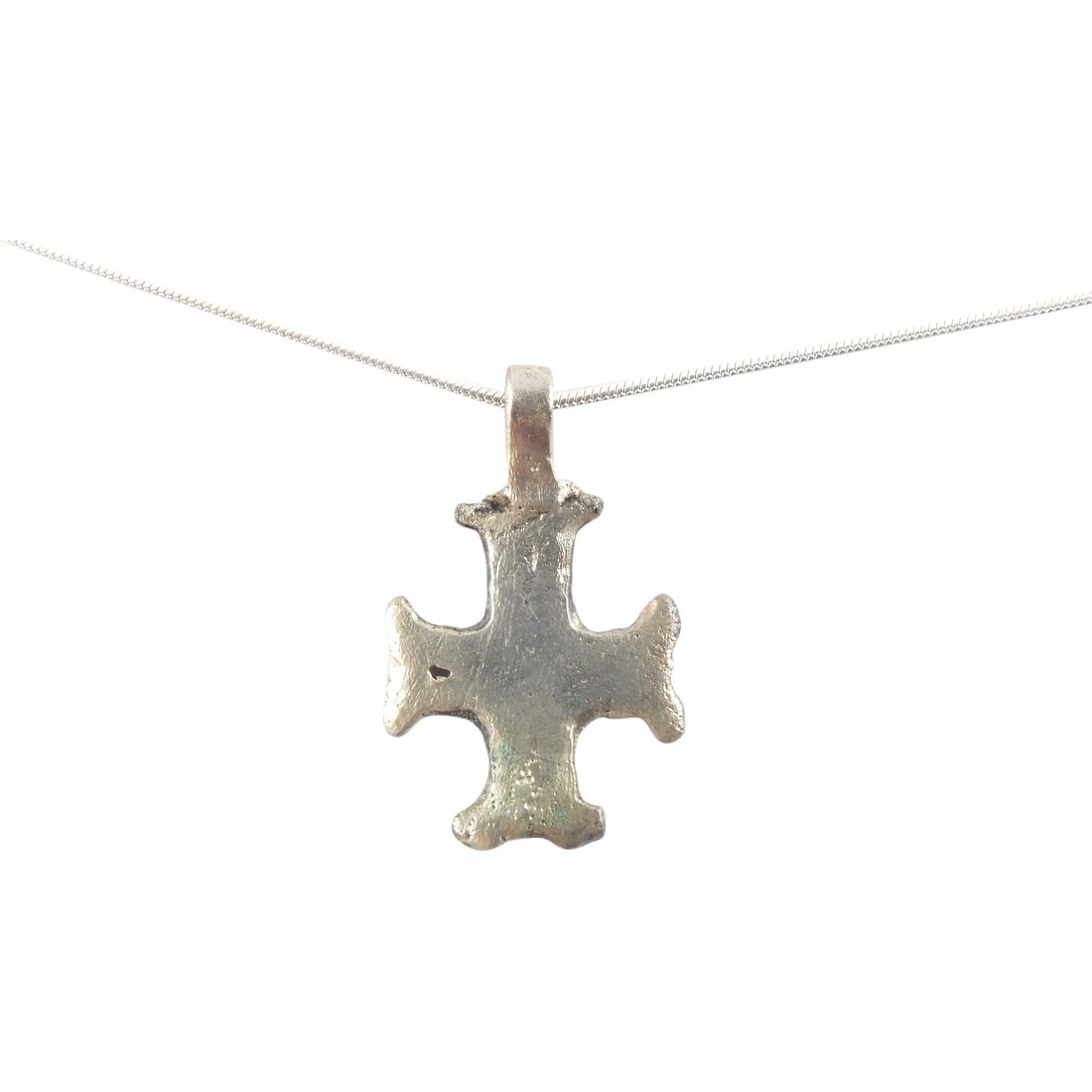 Byzantine Pilgrim’s Reliquary Cross 600-900 A.D.: Jewelry: Byzantine Pilgrim’s Reliquary Cross Date: 600-900 A.D. Size: 1.25 inch Material: Silver surface Broad flared terminal beams. The cross beam slightly below center. Reverse depressed for incl