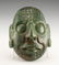 A carved jade mask in Pre-Columbian style
